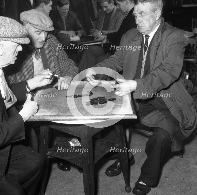A game of dominoes in a miners' welfare club, Horden, County Durham, 1963. Artist: Michael Walters