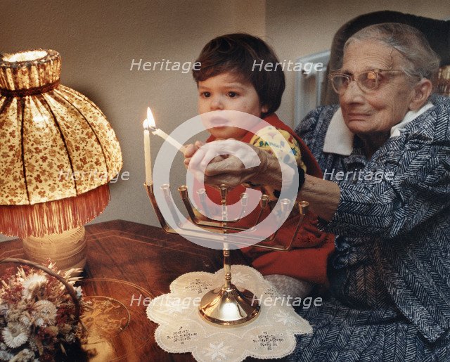 Girl lighting candles, Middlesex, London, 1989. Artist: Unknown
