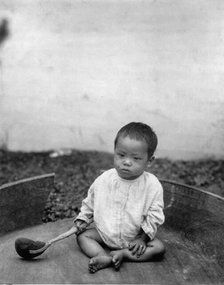 Asian(?) baby seated holding spoon or ladle, World's Columbian Exposition, Chicago, Ill., 1891 or 92 Creator: Frances Benjamin Johnston.