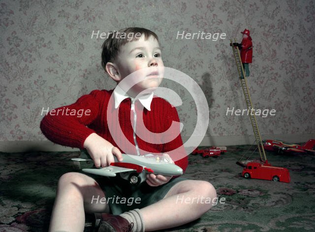 Boy playing with a toy aeroplane, c1960s. Creator: Arthur Charles Kirby Ware.