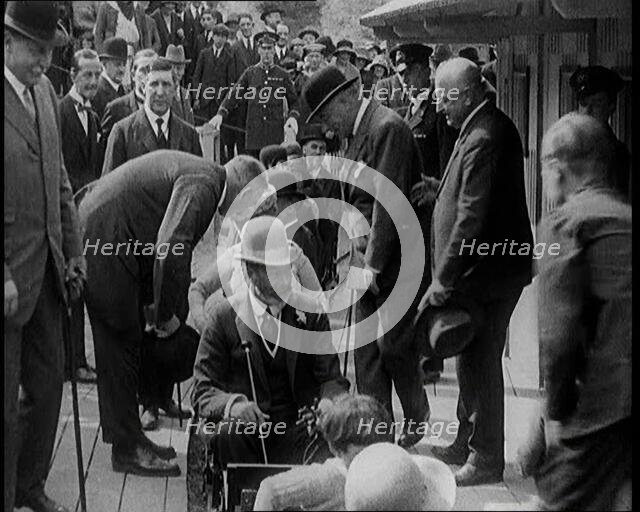 King George V of the United Kingdom Sitting On a Model Train With a Crowd of People Watching, 1924. Creator: British Pathe Ltd.