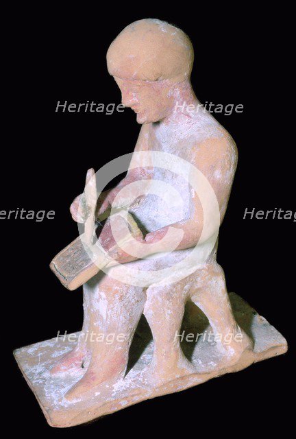 Greek terracotta of a man writing. Artist: Unknown