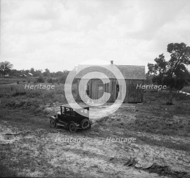 Home in a district from which many families immigrate West, near Sallisaw, Oklahoma, 1938. Creator: Dorothea Lange.