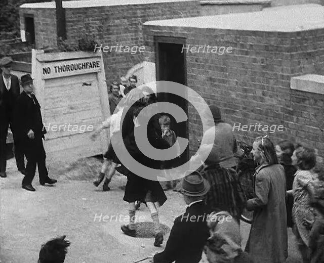 Civilians Entering an Air Raid Shelter to Escape German Shelling, 1940. Creator: British Pathe Ltd.