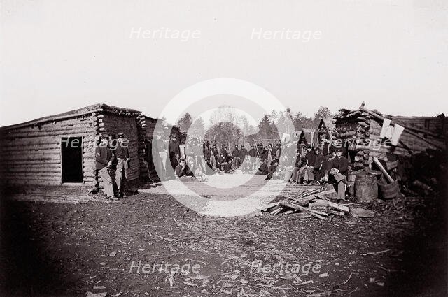 [Winter Quarters, troops with row of cabins]. Brady album, p. 128, 1861-65. Creator: Unknown.