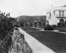 Pasadena, California, Mrs. Herbert Coppell home - view of formal lawn, gardens, and hills..., 1917. Creator: Frances Benjamin Johnston.