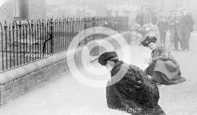 Emma Sproson (left) and a friend chalking the pavement, 1907. Artist: Unknown