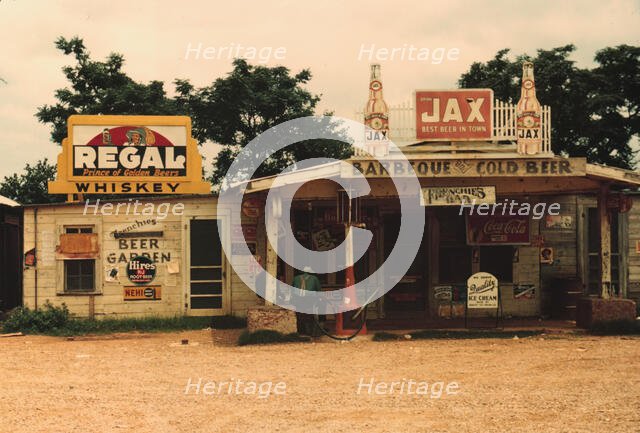 A cross roads store, bar, "juke joint," and gas...in the cotton plantation area, Melrose, La., 1940. Creator: Marion Post Wolcott.