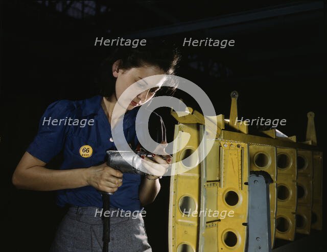 Drilling horizontal stabilizers...this woman worker at Vultee-Nashville..., Tennessee, 1943. Creator: Alfred T Palmer.