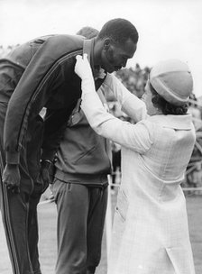 Queen Elizabeth II awards Kip Keino his gold medal, Commonwealth Games, Edinburgh, 1970. Artist: Unknown