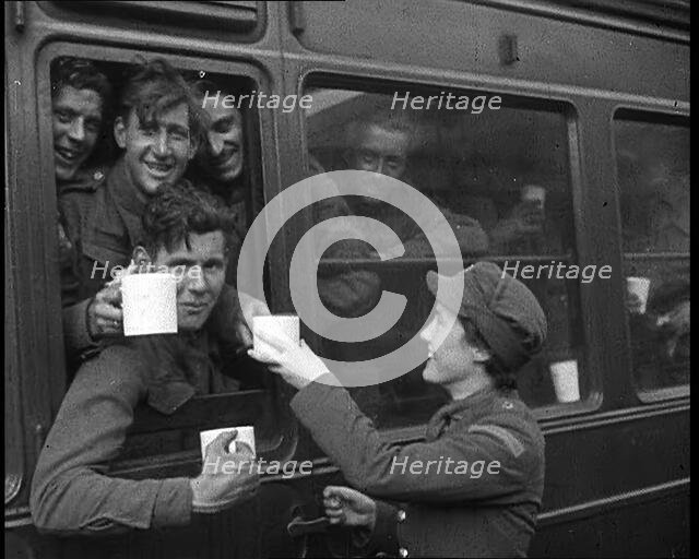 British Soldiers Receiving Food and Drink on the Train Back To Camp, 1940. Creator: British Pathe Ltd.