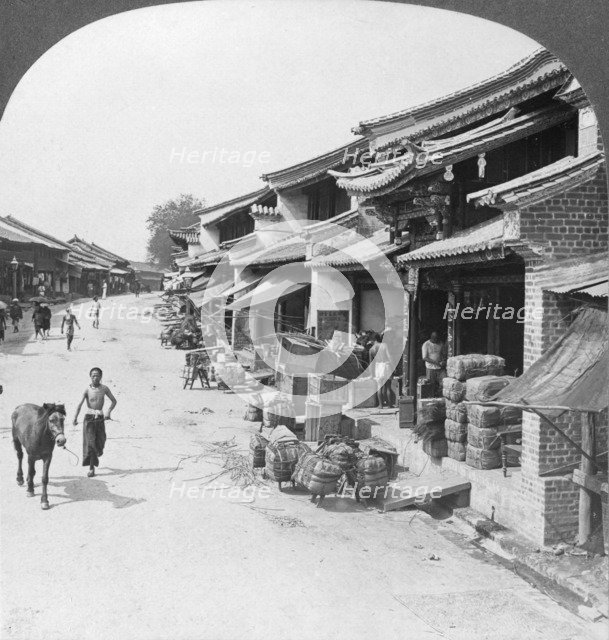 Main business street of the Chinese quarter, Bhamo, Burma, 1908. Artist: Stereo Travel Co
