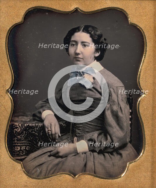Seated Young Woman Wearing Collar with Large Bow, Resting Arm on Table, 1850s. Creator: Unknown.
