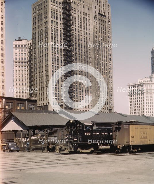 Diesel switch engine moving freight cars at the South water...Illinois Central R.R., Chicago, 1943. Creator: Jack Delano.