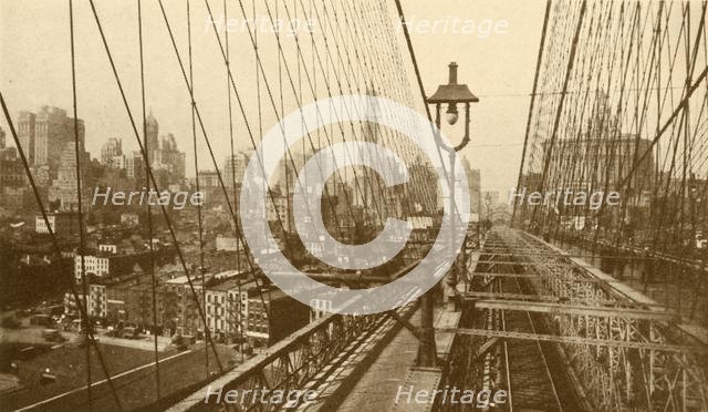 'Lower Manhattan Viewed Through The Network Of Cables On Brooklyn Suspension Bridge', c1930. Creator: ENA.
