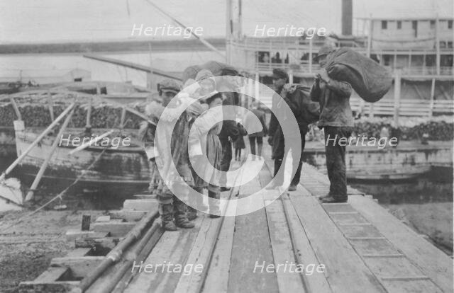Eskimos on a dock, between c1900 and 1916. Creator: Unknown.