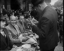 French Police Checking People's Papers Outside a Cafe in Paris, 1940. Creator: British Pathe Ltd.