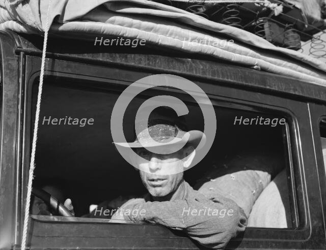 Migratory cotton picker on highway near Merced, California, 1939. Creator: Dorothea Lange.