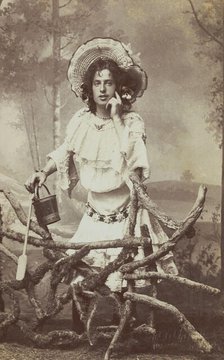 A sailor in drag posed behind a wooden fence, 1906. Creator: Unknown.