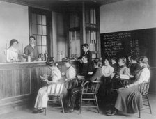 Students in a chemistry class observing others conducting an experiment...Washington DC, (1899?). Creator: Frances Benjamin Johnston.