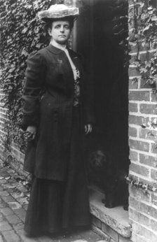 Frances Benjamin Johnston, in doorway with cocker spaniel, n.d.. Creator: Frances Benjamin Johnston.