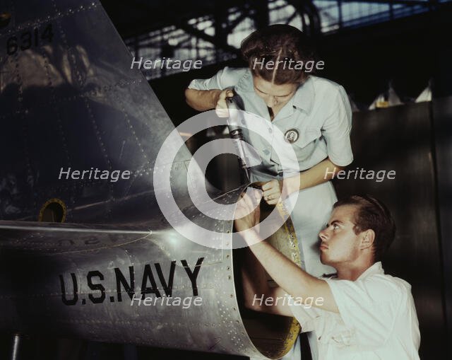 Mrs. Virginia Davis, a riveter in the assembly and repair department of the Naval air base..., 1942. Creator: Howard Hollem.