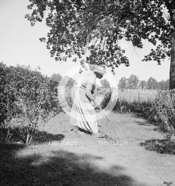 Caroline Atwater, wife of Negro owner, has a well-swept yard, 1939. Creator: Dorothea Lange.