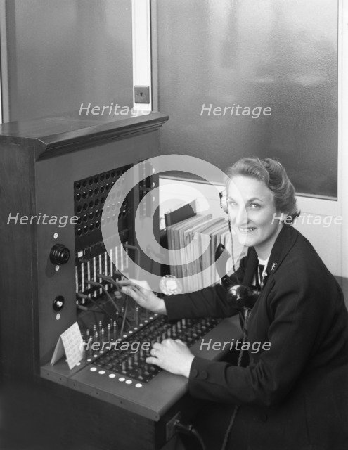 Switch board operator, Spillers Animal Foods, Gainsborough, Lincolnshire, 1960. Artist: Michael Walters