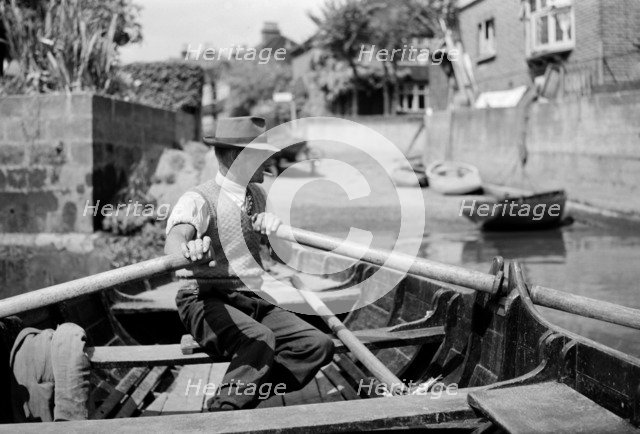 Man rowing the Twickenham ferry boat, Twickenham, c1945-c1965. Artist: SW Rawlings