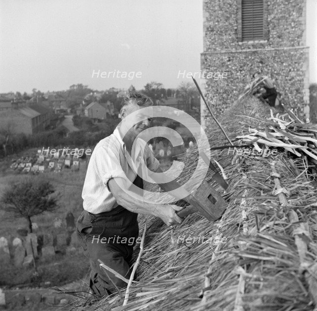 Thatching the roof of St Margaret & All Saints church, Pakefield, Suffolk, 1949. Artist: Hallam Ashley