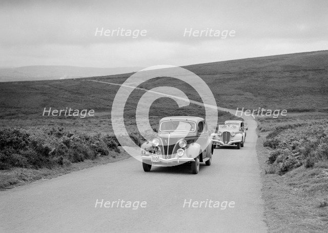 GM Denton's Ford V8 leading the Delahaye of DA Loader at the MCC Torquay Rally, July 1937. Artist: Bill Brunell.