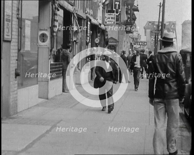 Crowds Walking Down a Pavement, 1930s. Creator: British Pathe Ltd.