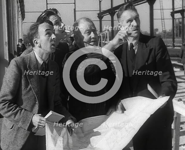 American Engineers Going Over Construction Plans of a Hangar at an Airfield in England, 1943-1944. Creator: British Pathe Ltd.