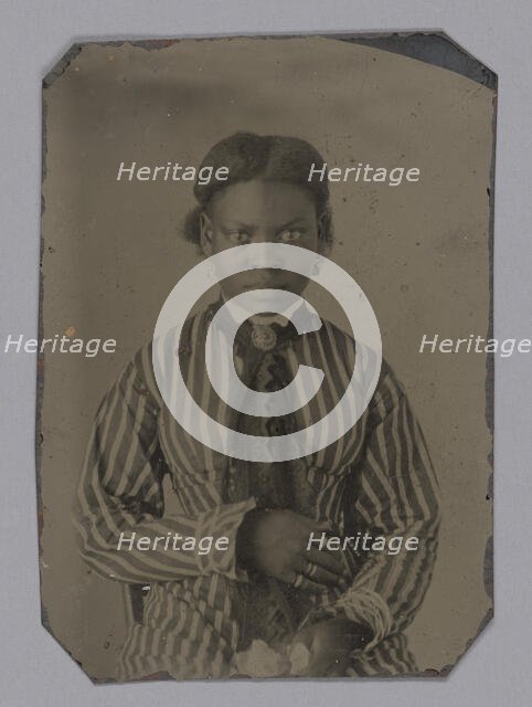 Tintype of young woman in striped dress, Late 1860s. Creator: Unknown.