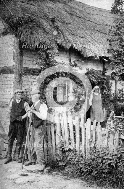 Two men chatting outside a cottage, near Lucton, Herefordshire, c1922.Artist: AW Cutler