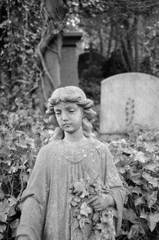 Statue of a girl holding flowers, Highgate Cemetery, Hampstead, London, 1995. Artist: John Gay.