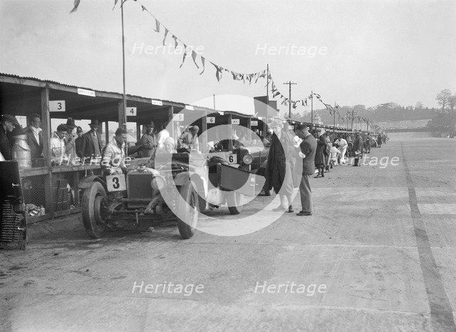 Invicta of FH Cairnes and George Field in the pits at the JCC Double Twelve race, Brooklands, 1931. Artist: Bill Brunell.