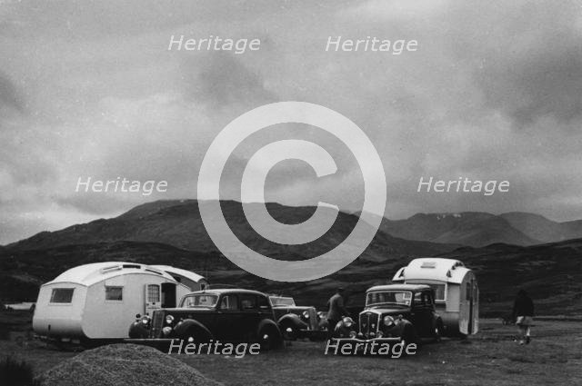 Group of cars and caravans camping in Scottish Highlands 1930's. Creator: Unknown.