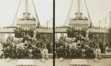 Sailors, probably American, and some civilians posed on a cruiser berthed in New York(?), c1905. Creator: Underwood & Underwood.