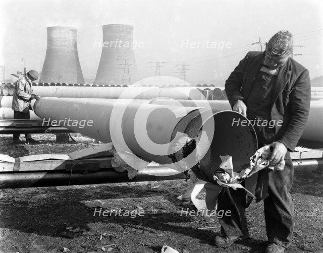 Pipe wrapping to prevent corrosion on steel pipes, Old Denaby, South Yorkshire, 1961. Artist: Michael Walters
