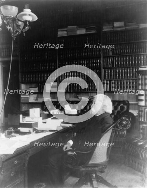 Melville Weston Fuller, full-length portrait, seated at desk, facing left, c1899. Creator: Frances Benjamin Johnston.