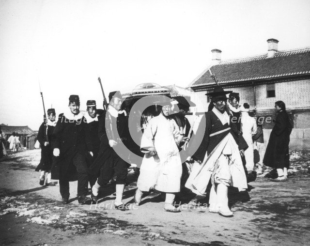 Japanese official with an escort of soldiers, Korea, c1900. Artist: Unknown