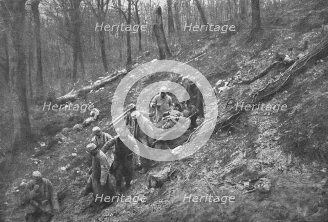 'Aux Eparges; Le transport des blesses sur les pentes boisees des Eparges', 1915 (1924). Creator: Unknown.