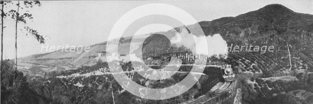 'A Scene on the Up-Country Railway. Passing a Tea Estate at Nanu Oya', c1890, (1910). Artist: Alfred William Amandus Plate.