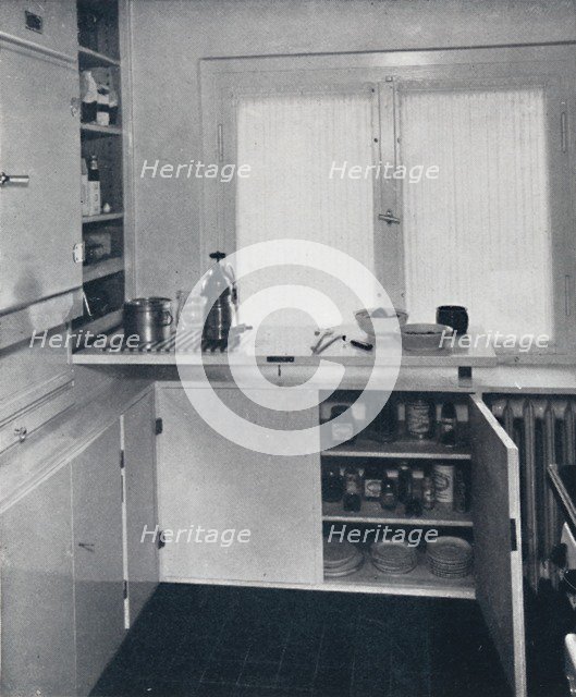 'Werner Harting - Kitchen with a black Dutch tiled floor, white walls and built-in shelves and cupbo Artist: Unknown.