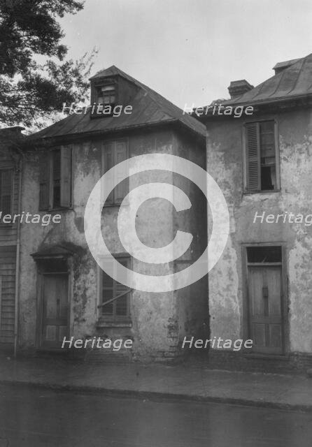 Facades of two-story houses, [Alexander Peronneau Tenements, 141 Church Street..., c1920-1926. Creator: Arnold Genthe.