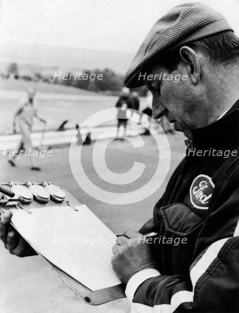 Ken Tyrrell noting down times, (c1970s?). Artist: Unknown