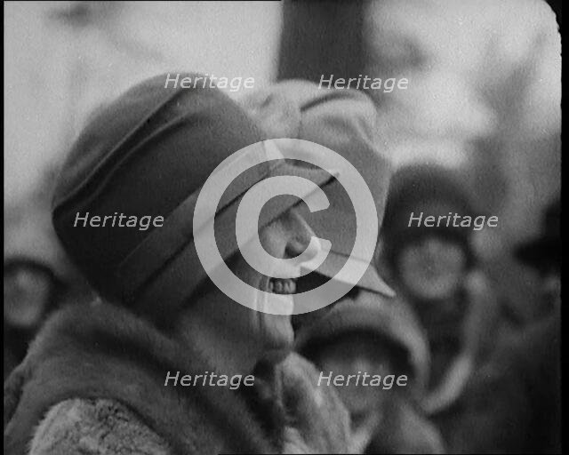 Two Female Civilians Wearing Heavy Coats and Hats Standing in Front of a Car, 1920. Creator: British Pathe Ltd.
