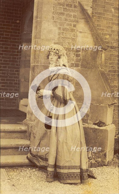 A man in drag posing in historical costume, (between 1890 and 1899?). Creator: Unknown.