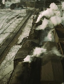 Locomotives lined up for coal, sand and water at the coaling station in the 40..., Chicago, 1942. Creator: Jack Delano.